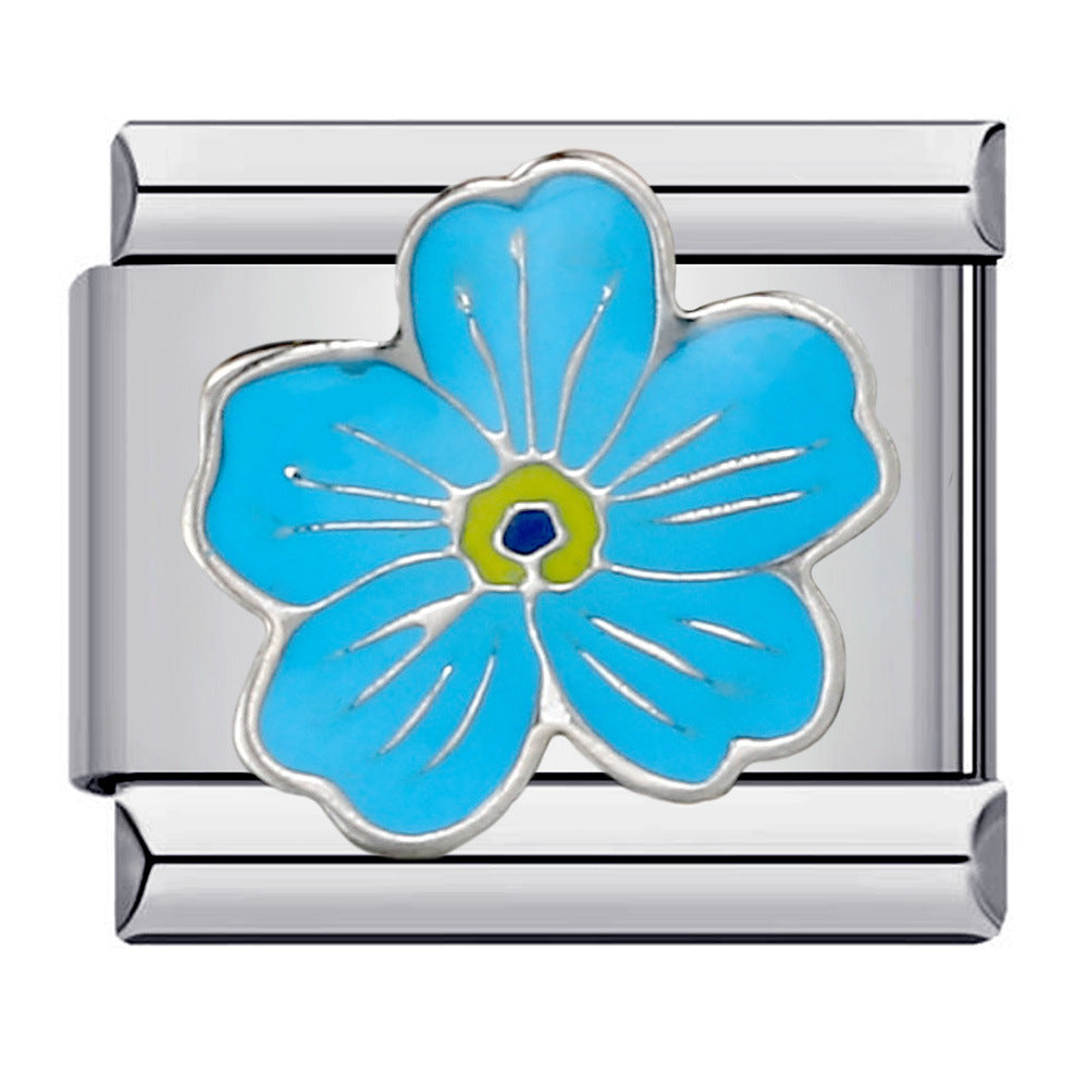 A silver-toned Italian charm link featuring a stylized five-petal flower with light blue enamel petals, a yellow-green center, and a small blue accent.