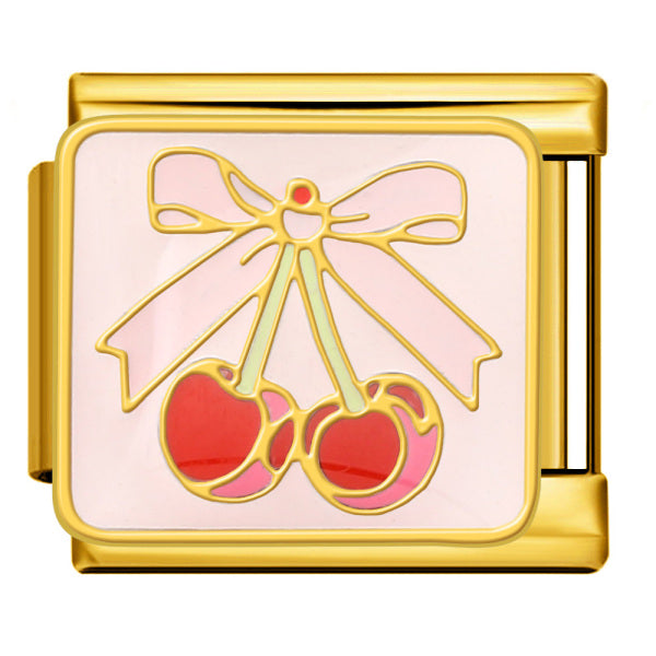 Gold charm with cherry and bow design on a light pink background