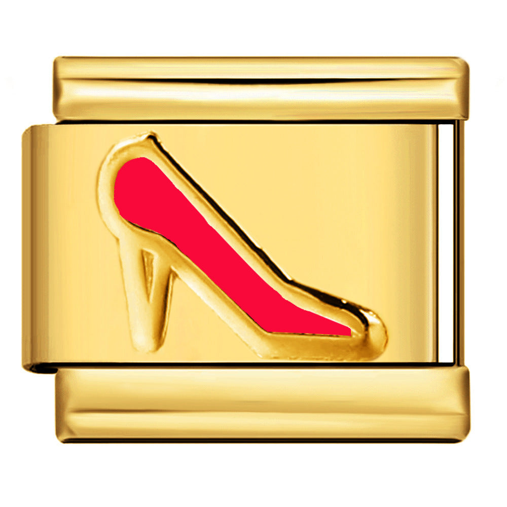 A gold-toned rectangular charm link featuring an enamel high-heeled shoe design in red