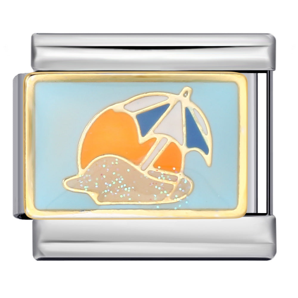 Silver-toned charm link featuring a blue and white beach umbrella, glittery sand against a light blue backdrop and orange sun.