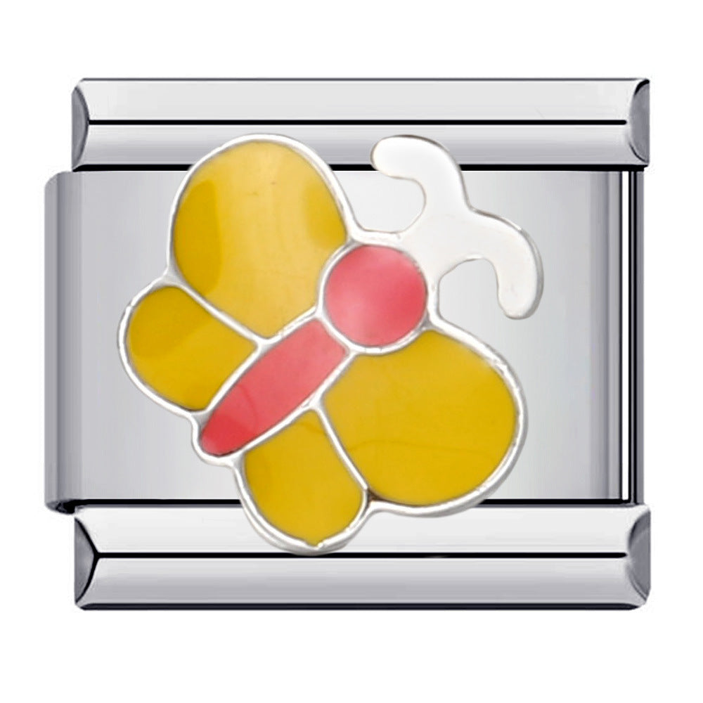 A silver-toned modular Italian charm link featuring a butterfly design with yellow wings, a pink body, and a white antennas