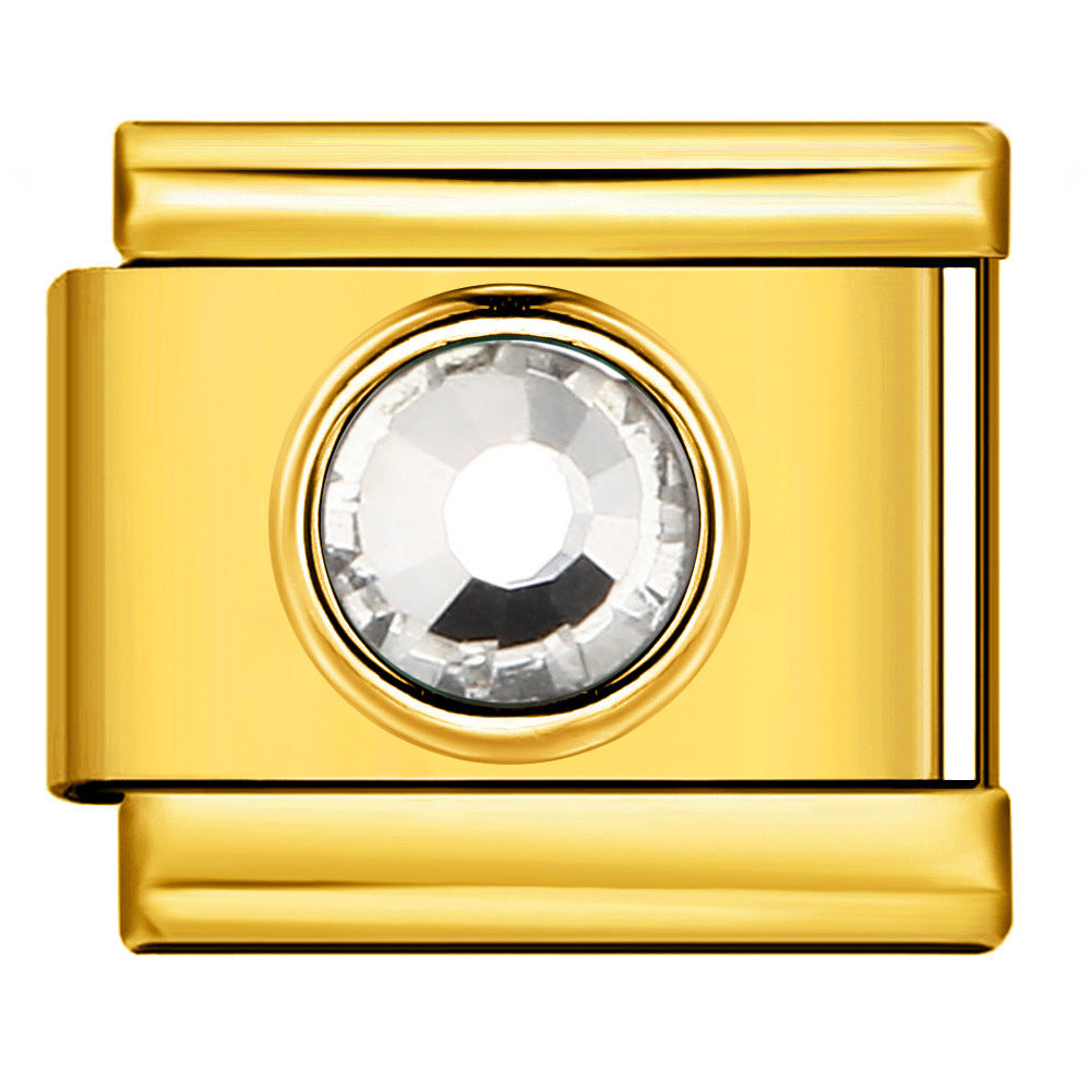 Gold charm with a central crystal on a white background