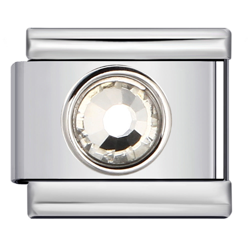 A polished silver-tone metal charm link featuring a round, faceted clear crystal centerpiece, shown against a plain white background.
