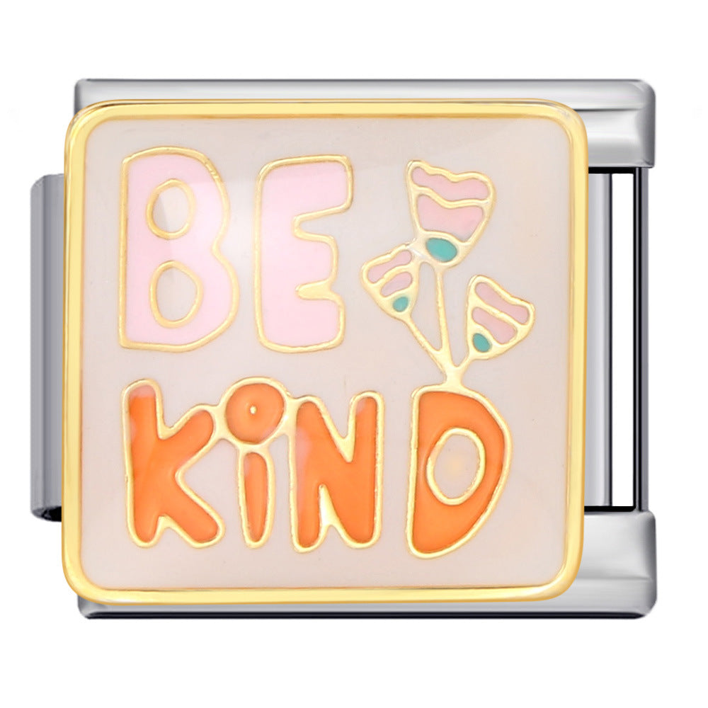 Silver-toned charm link that says "be' in pink letters, 'kind' in orange letters, with pink flowers and gold outlines.