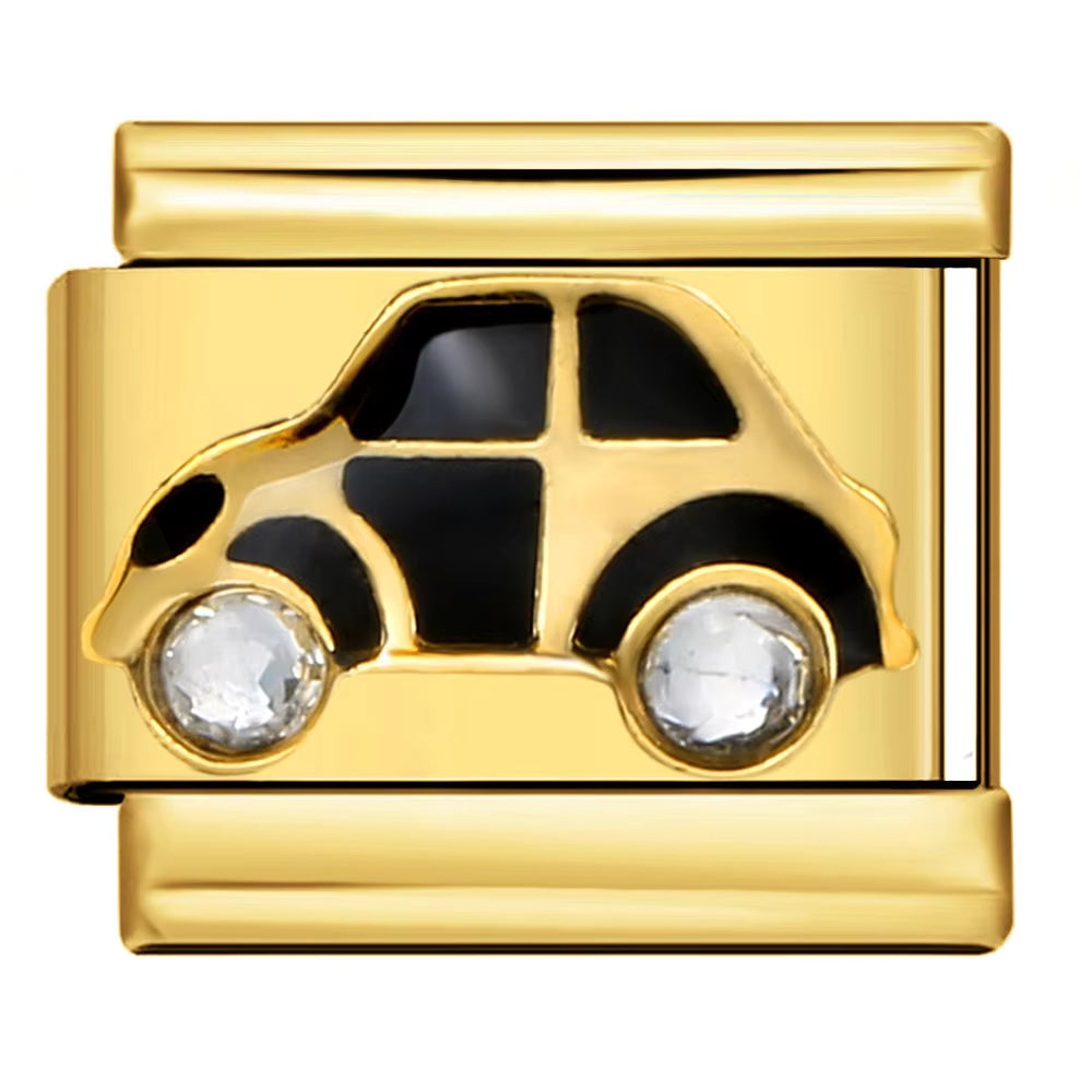 Gold charm with black car design and clear stones on a plain background