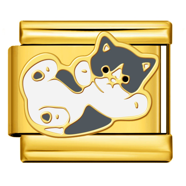 A gold-toned rectangular charm link featuring an enamel cat design in black and white