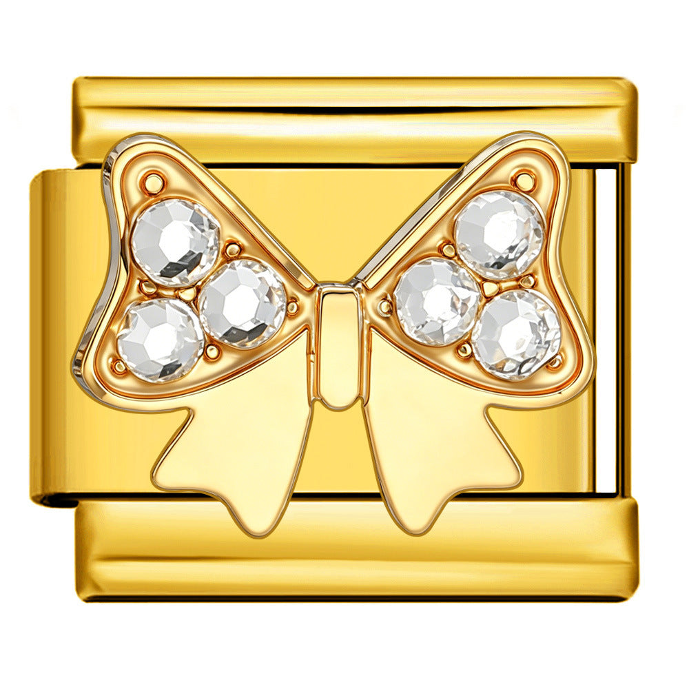 Gold bow-shaped charm with embedded crystals