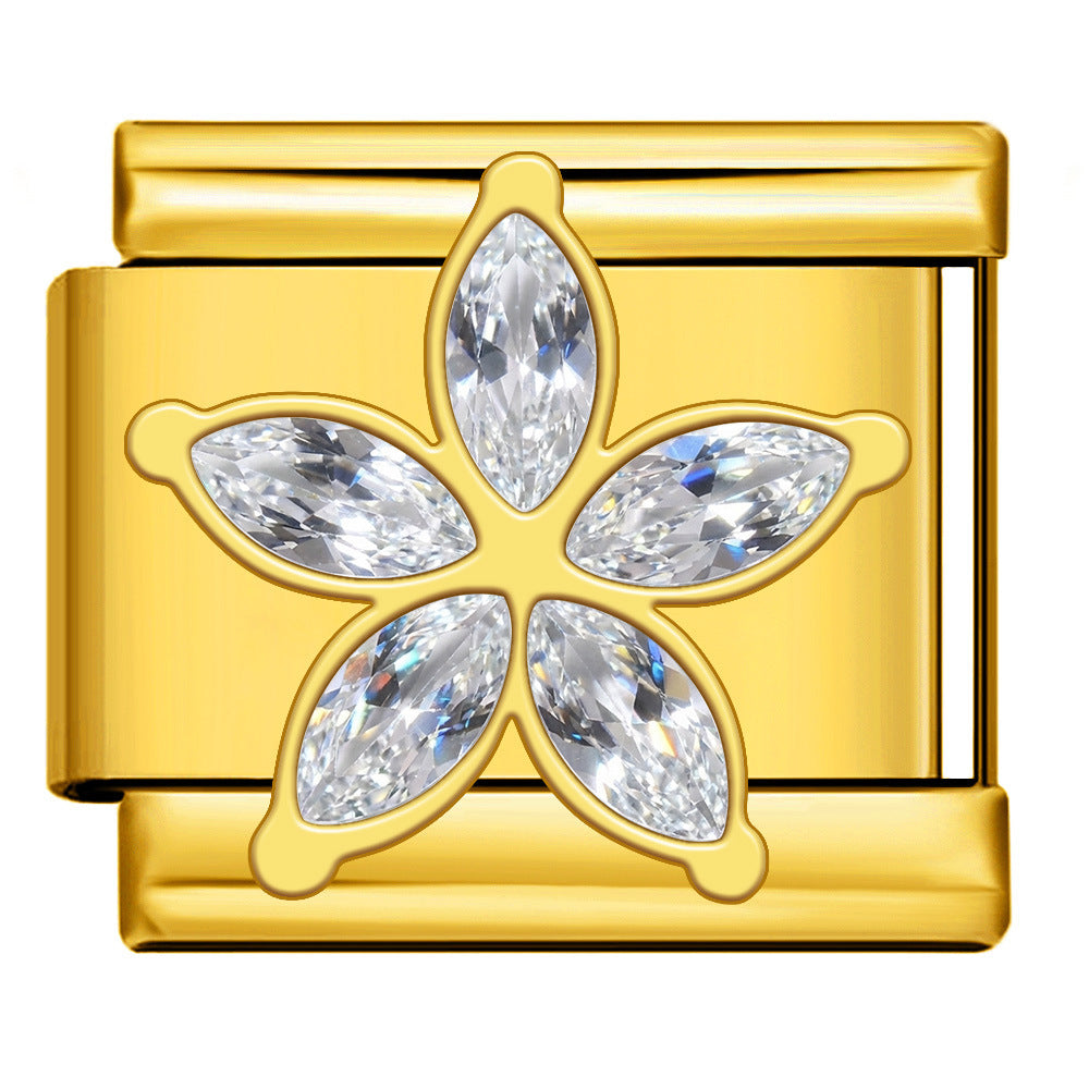 Gold charm with diamond-like stones in the shape of a flower
