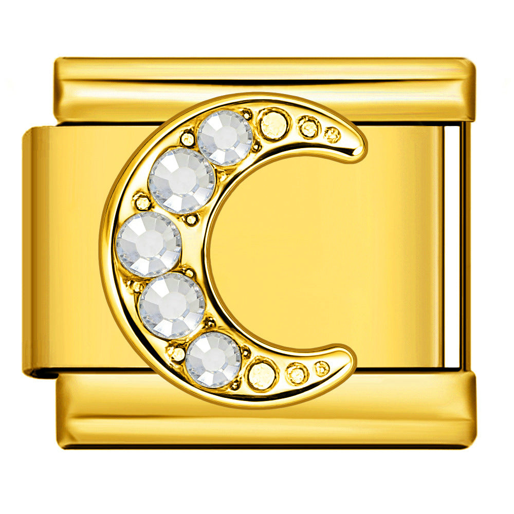 Gold charm with a crescent moon design and embedded crystals