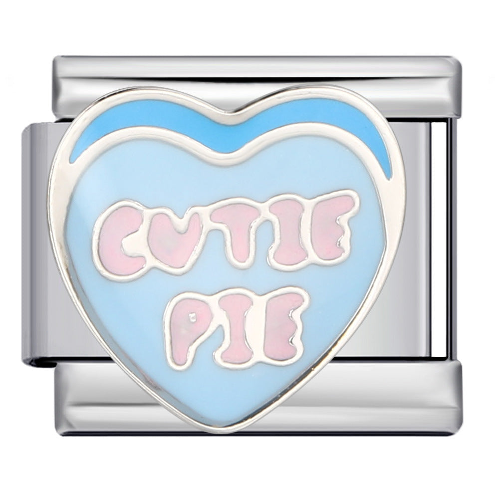 A silver-toned charm link featuring a light blue enamel heart with pink lettering that reads 'CUTIE PIE' outlined in white.