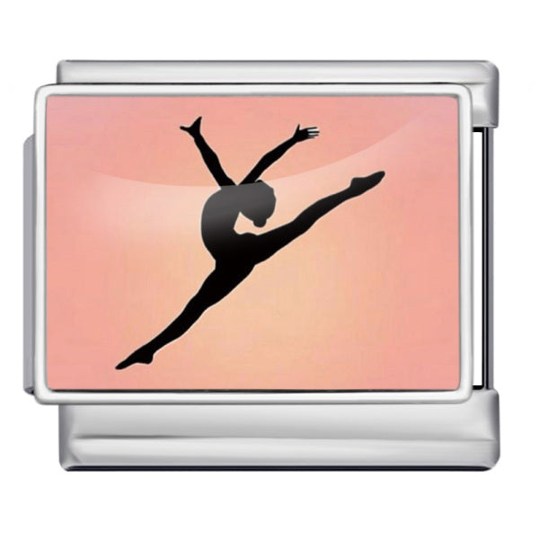 A silver-toned charm with a printed design of a black silhouette of a gymnast or dancer against a soft peach-pink gradient background.