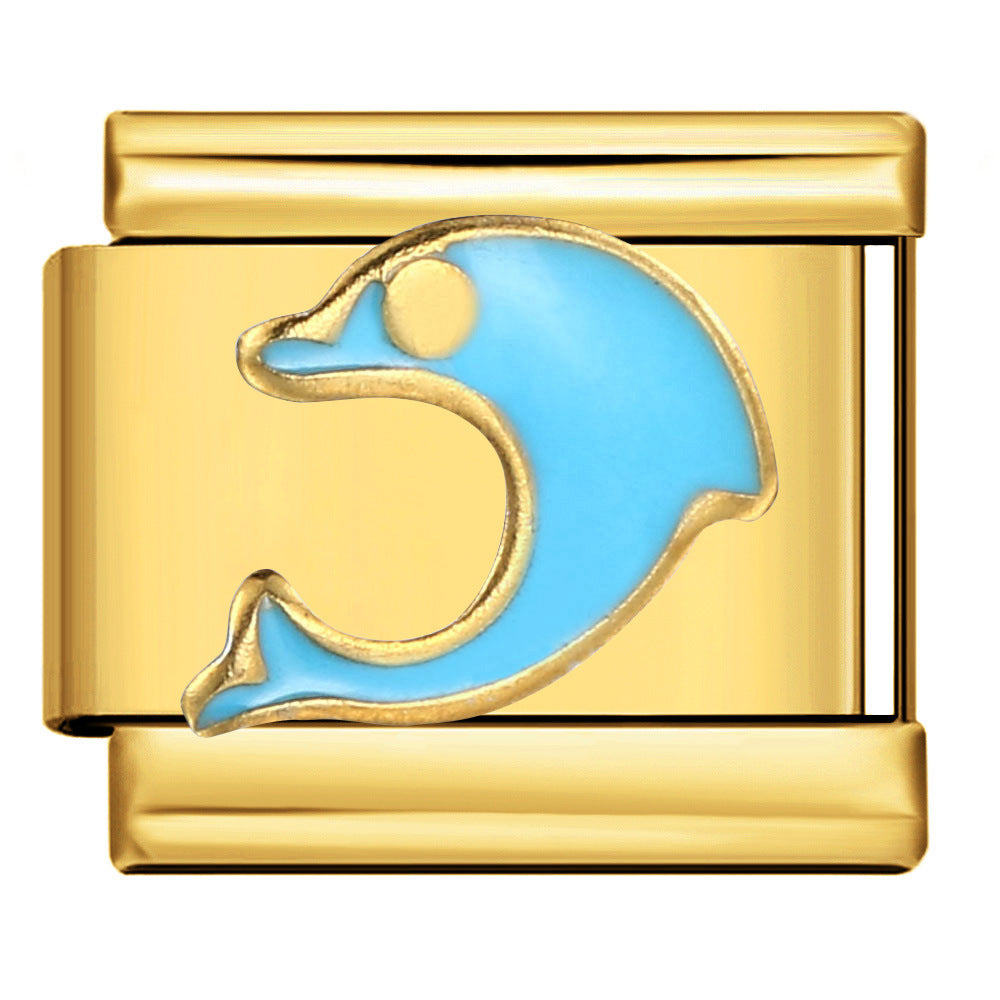 A gold-toned modular charm link featuring a stylized dolphin design filled with light blue enamel