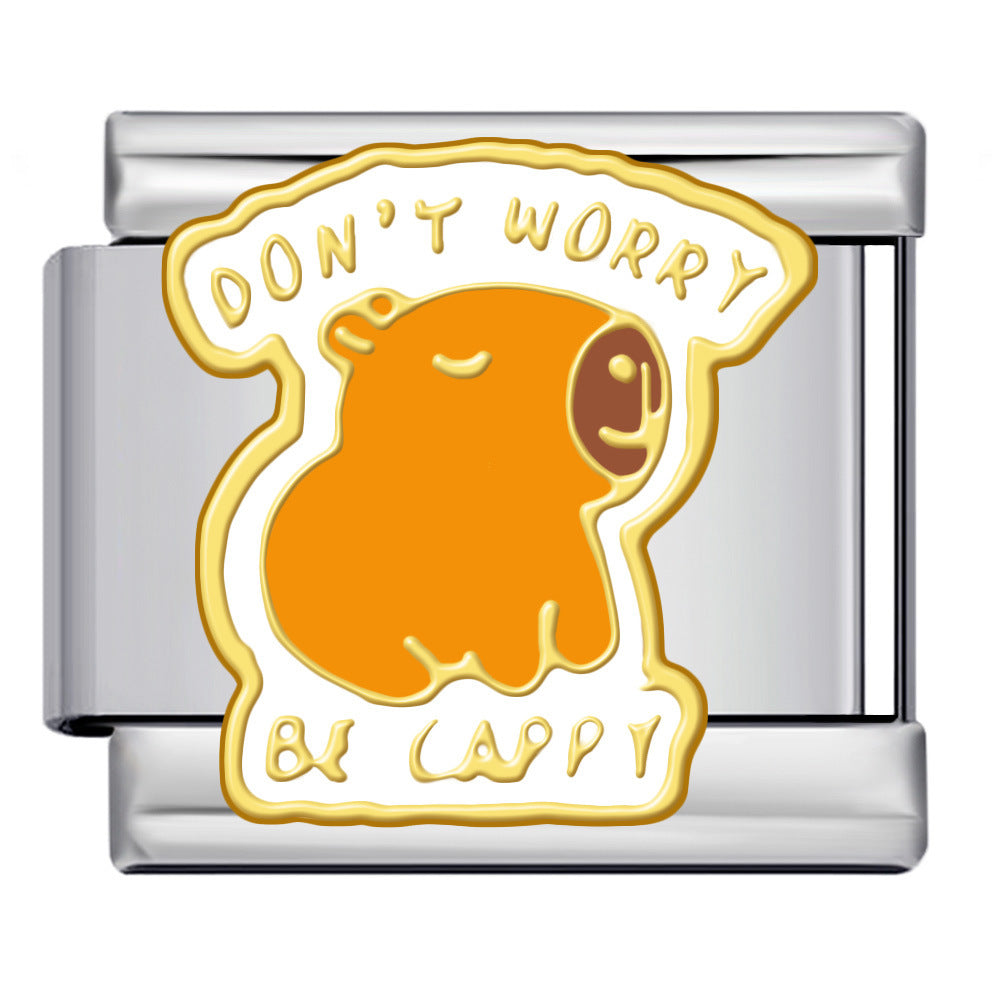 A silver-toned Italian charm link featuring a cute orange capybara illustration with the text 'DON'T WORRY BE CAPPY' in yellow and white enamel.