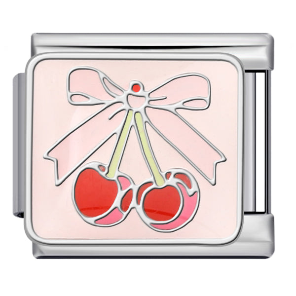 A silver-toned rectangular charm link featuring an enamel design of two red cherries under a light pink bow on a pale pink background.