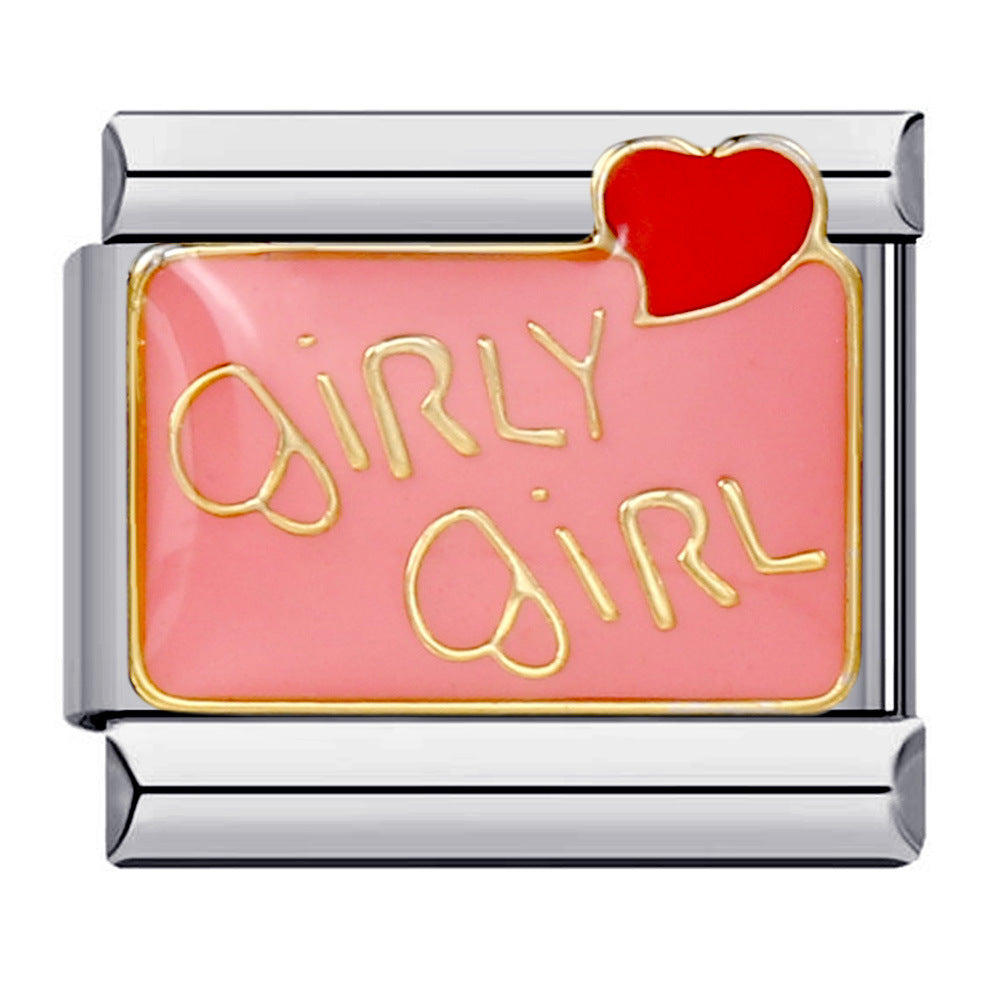 silver toned charm with 'girly girl' written in gold letters against a pink background with a small red heart