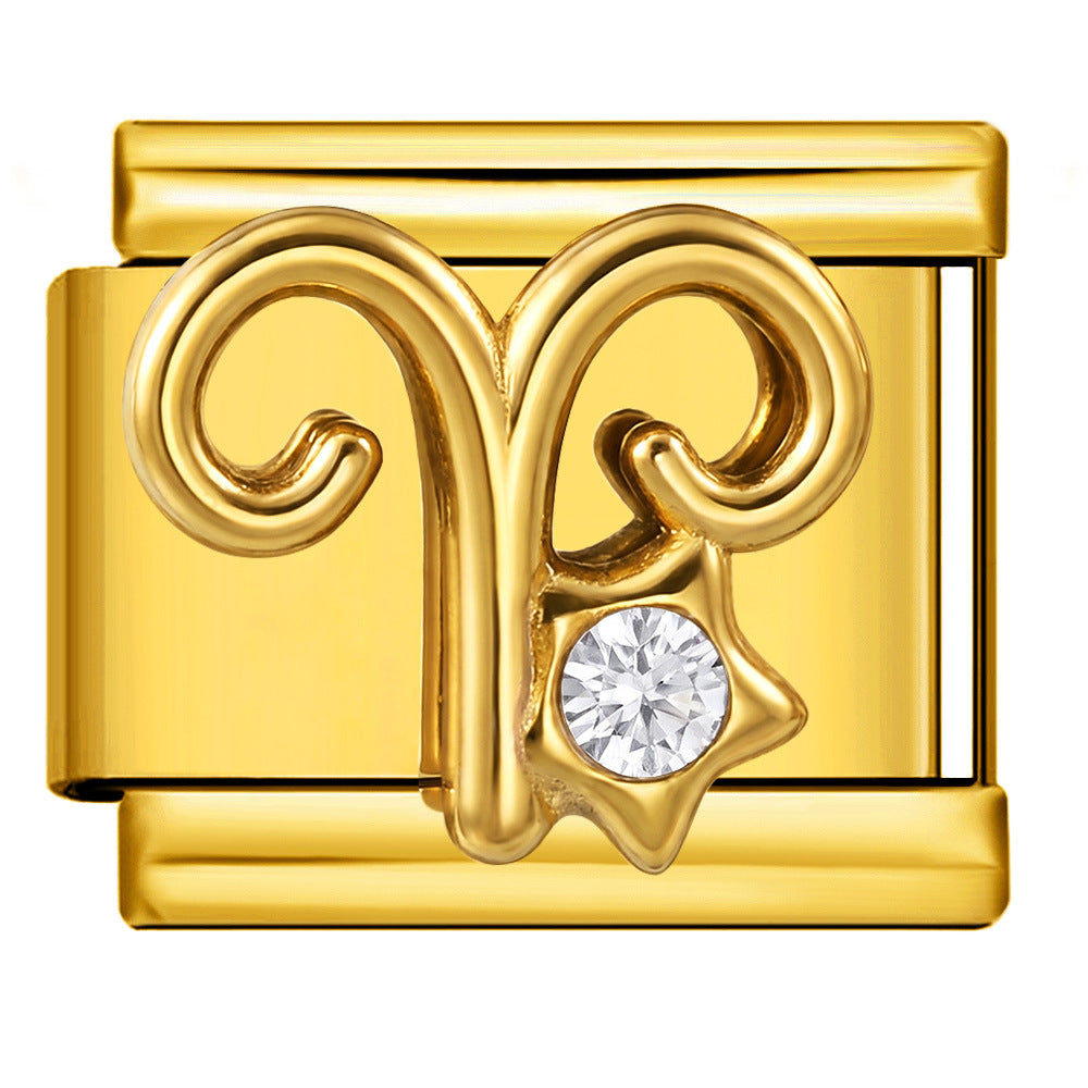 A gold-tone Aries zodiac symbol charm link with a clear round-cut gemstone 