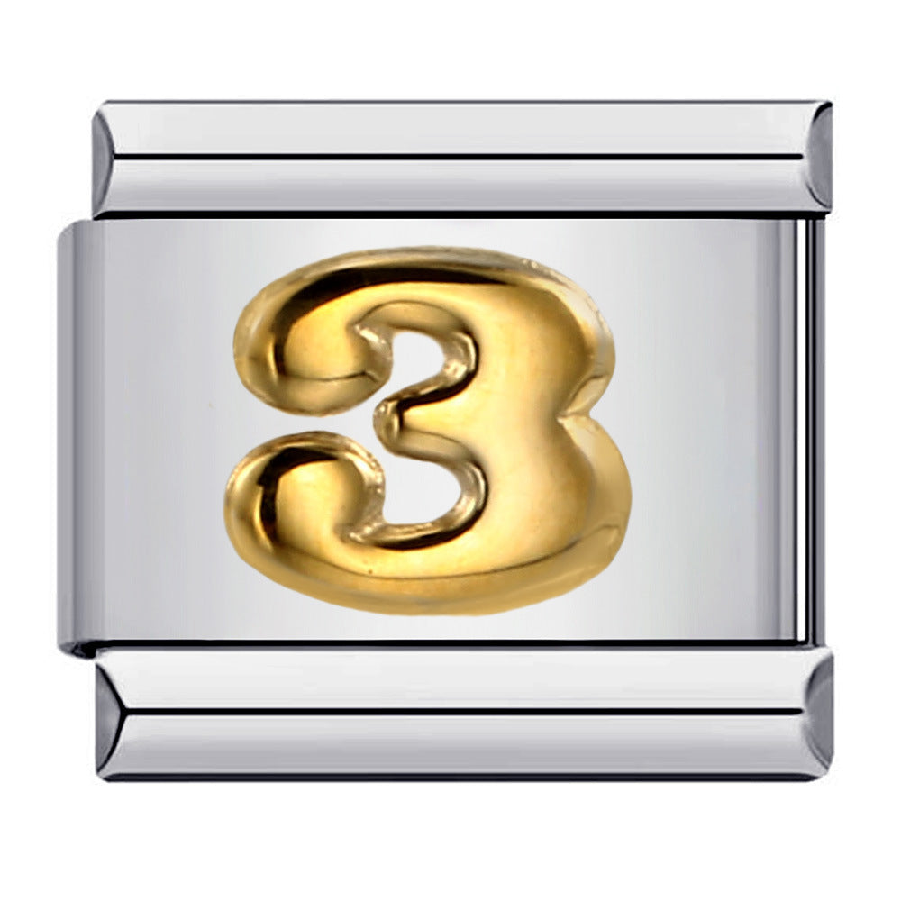 Silver charm with a gold number '3'