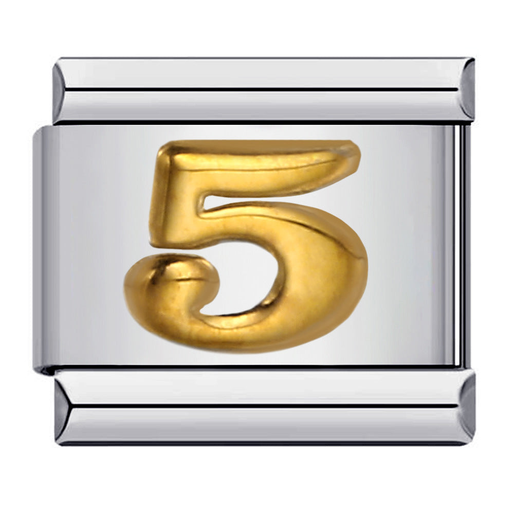 Silver charm with a gold number '5' 