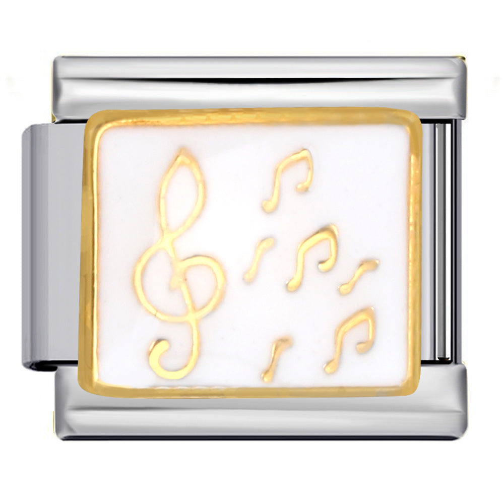 Silver-toned Italian charm ink with gold music notes on a white background