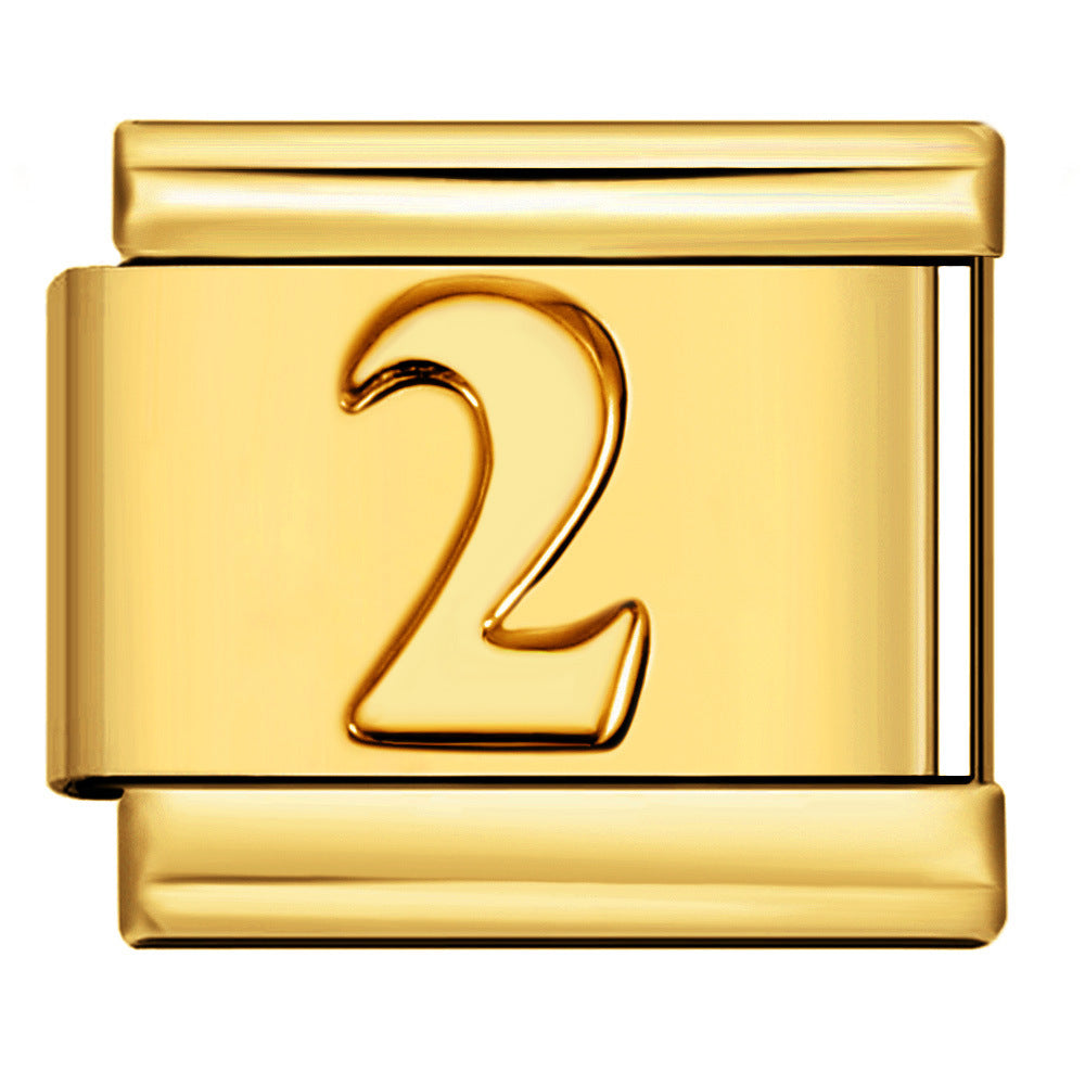 A polished gold-toned metal charm link with a raised numeral '2' on the front