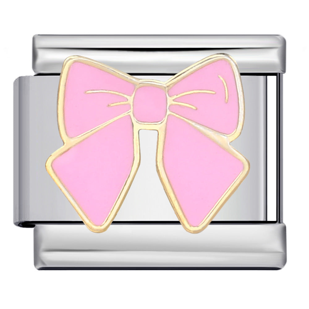 Silver charm with a pink bow design