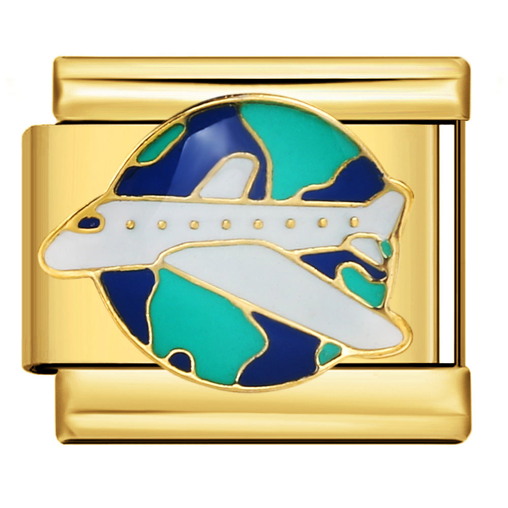Gold Travel the World Italian Charm featuring a white airplane flying across a navy blue and turquoise globe with gold outlines.