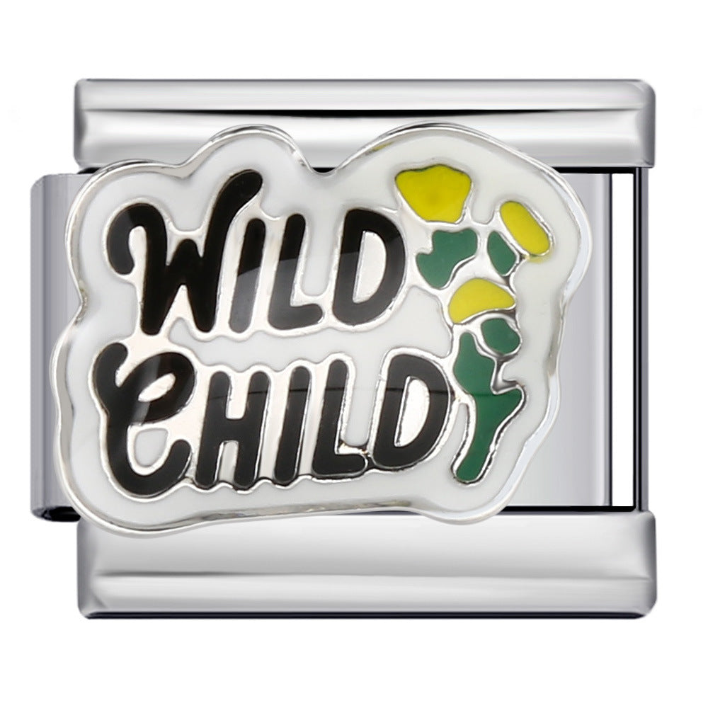 Silver-toned charm link that says 'wild child' in black letters against a white background with yellow flowers with green stems.